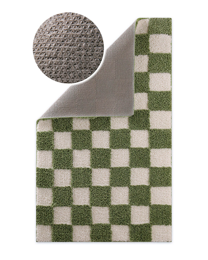 Badteppich Bobbi Grün Ecke umgeschlagen, graue Rückseite mit rutschhemmender Beschichtung sichtbar