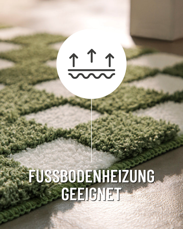 Badteppich Bobbi Grün Nahaufnahme der Teppichkante, Symbol zeigt Eignung für Fußbodenheizung