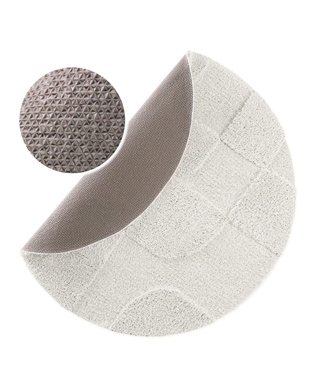 Badteppich Davie Weiß rund, angehobene Ecke zeigt graue Rückseite mit rutschhemmender Beschichtung