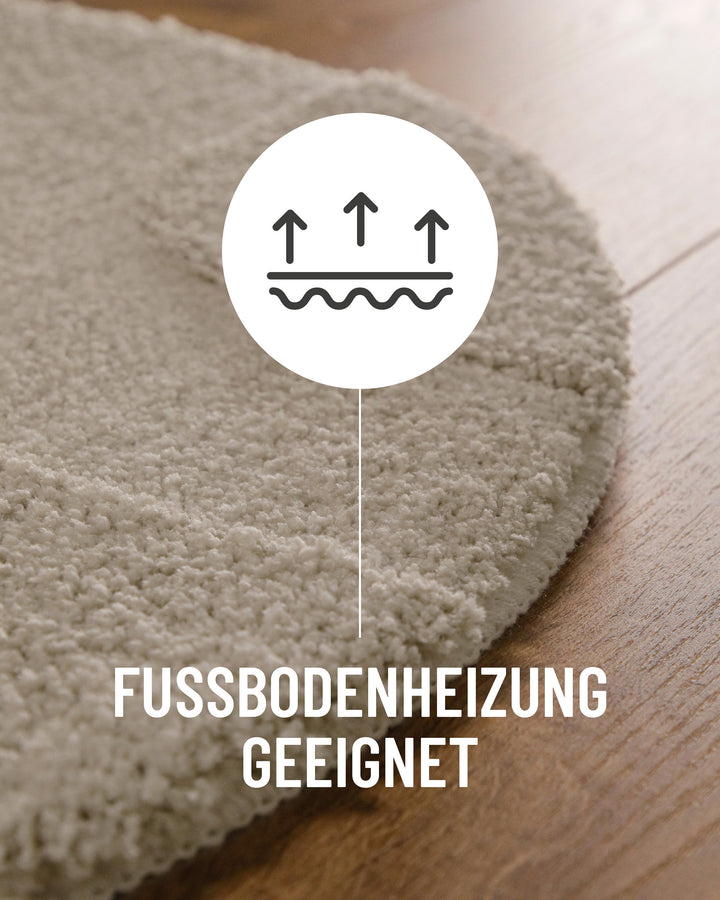 Badteppich Davie Grau Detail der Teppichkante auf Holzboden, Symbol weist auf Eignung für Fußbodenheizung hin