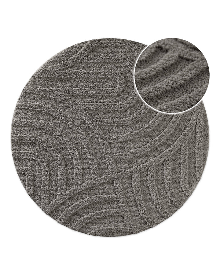 Badteppich Fiete Basalt Grau rund, Draufsicht mit Detailkreis der Florstruktur und eingeprägtem Linienmuster auf hellem Hintergrund