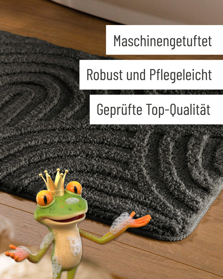 Badteppich Fiete Anthrazit Grau Detail der Teppichkante auf Holzfußboden, eingeblendete Hinweise zu Verarbeitung und Pflege