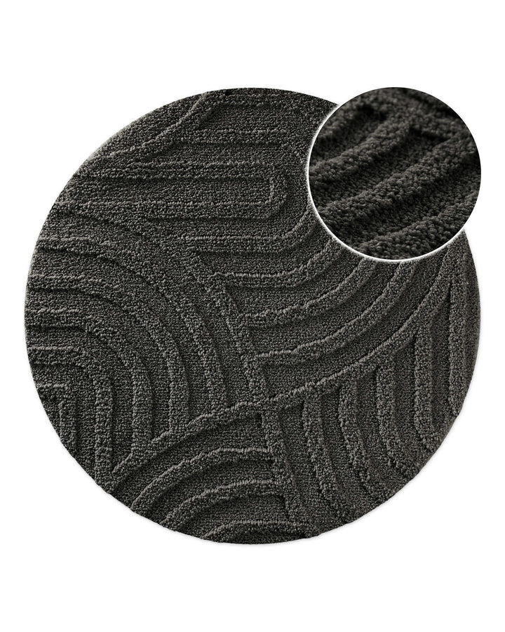Badteppich Fiete Anthrazit Grau rund, Draufsicht mit Detailkreis der Florstruktur und eingeprägtem Linienmuster auf hellem Hintergrund