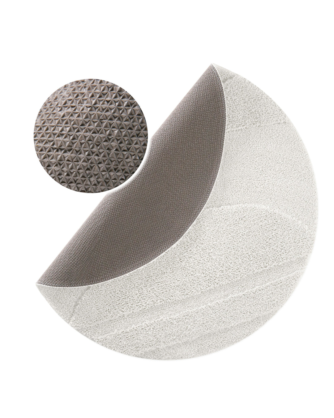 Badteppich Marc Weiß rund, angehobene Ecke zeigt graue Rückseite mit rutschhemmender Beschichtung