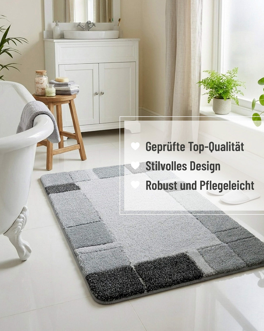 Badteppich Villa Elba in Grau in einem hellen Landhausbad mit freistehender Badewanne, weißem Unterschrank und Zimmerpflanzen, mit eingeblendeten Qualitätsversprechen: geprüfte Top-Qualität, stilvolles Design, robust und pflegeleicht