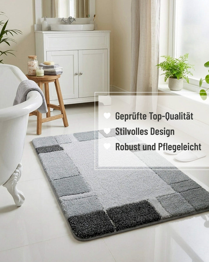 Badteppich Villa Elba in Grau in einem hellen Landhausbad mit freistehender Badewanne, weißem Unterschrank und Zimmerpflanzen, mit eingeblendeten Qualitätsversprechen: geprüfte Top-Qualität, stilvolles Design, robust und pflegeleicht