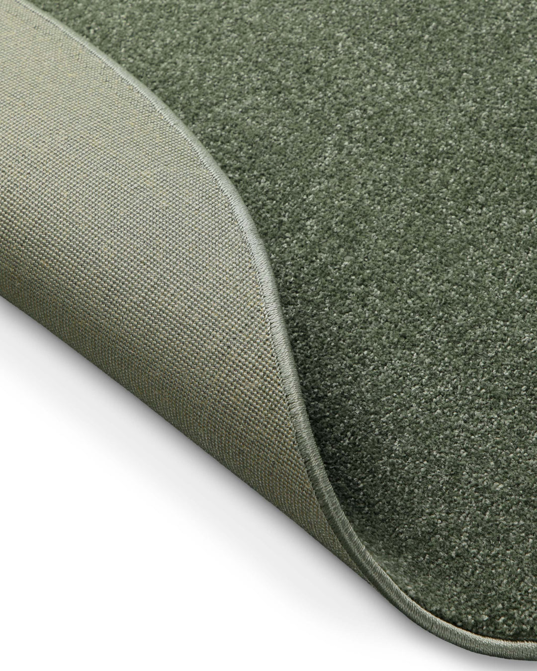 Kurzflor Teppich Freja Laub Grün rund Detail der umgelegten Ecke, Rückseite sichtbar