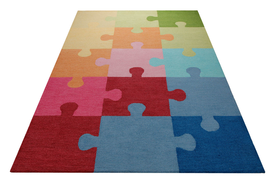 Puzzleteile bunt - Kinderteppich Wolle 160 x 230 cm – Teppich im Raum platziert